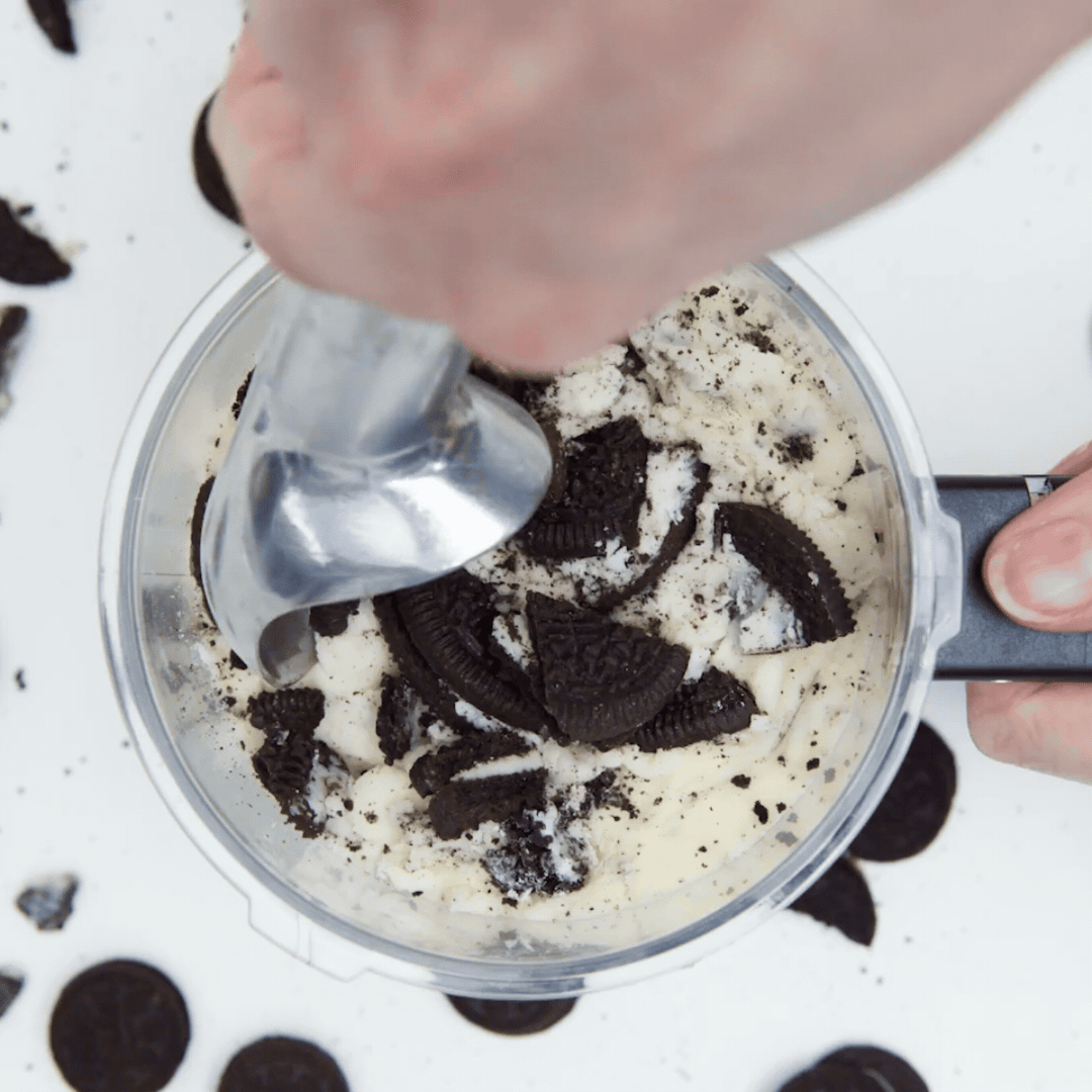 Short video of someone scoopinf oreo ice cream out of a canister