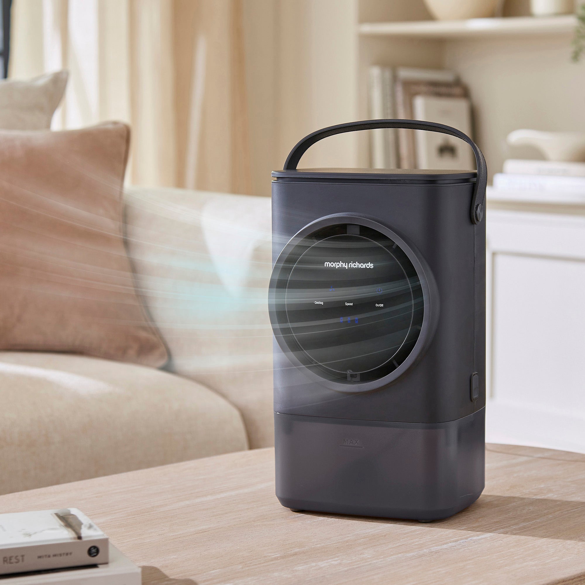 Portable air cooler on a coffee table in a living room setting