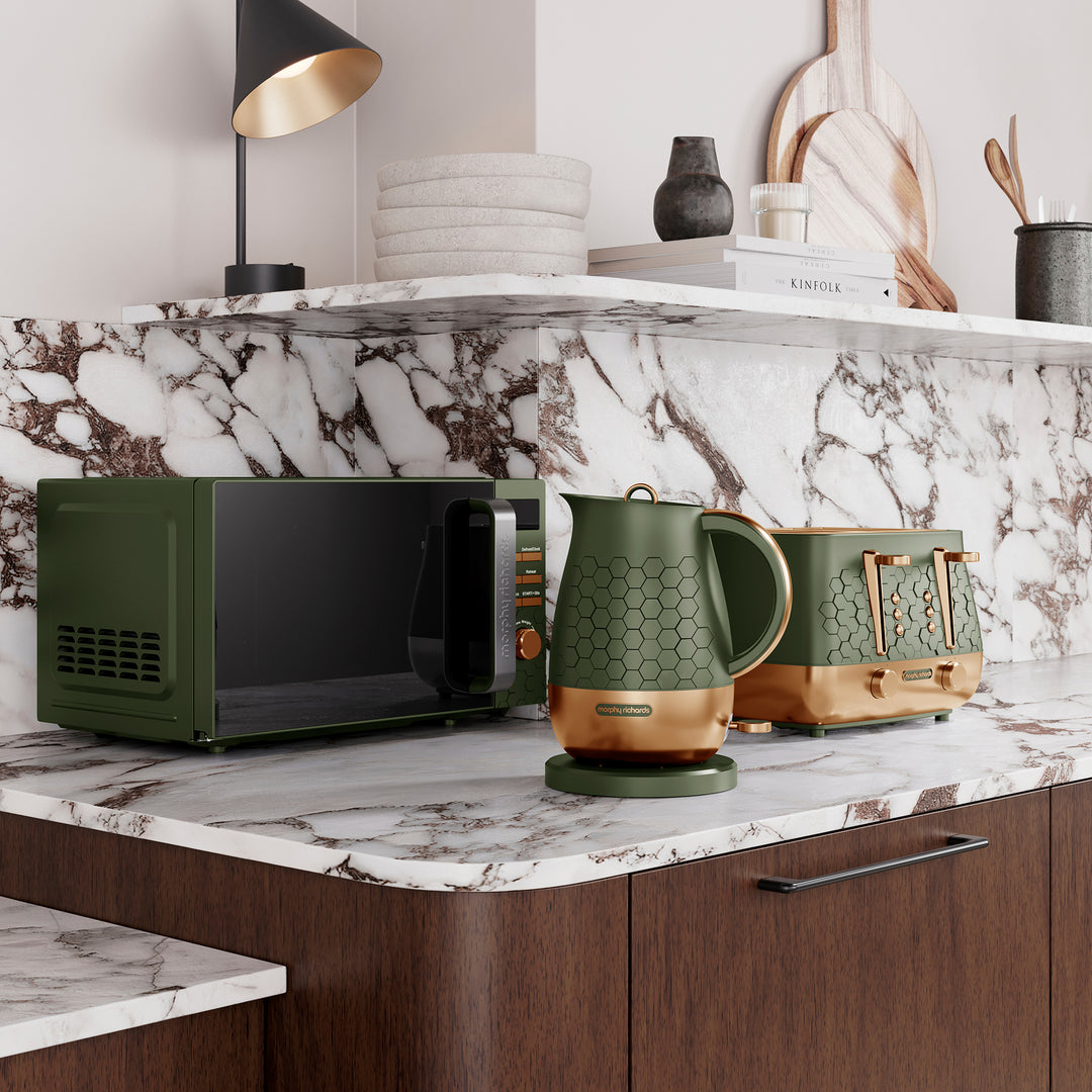 Morphy Richards Cassini green microwave, kettle, and toaster on a marble countertop with a shelf in the background.