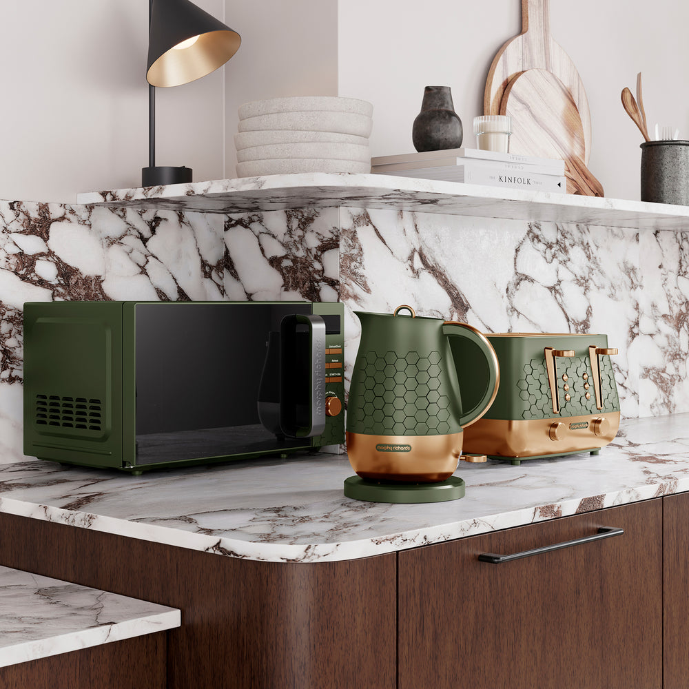Morphy Richards Cassini green microwave, kettle, and toaster on a marble countertop with a shelf in the background.