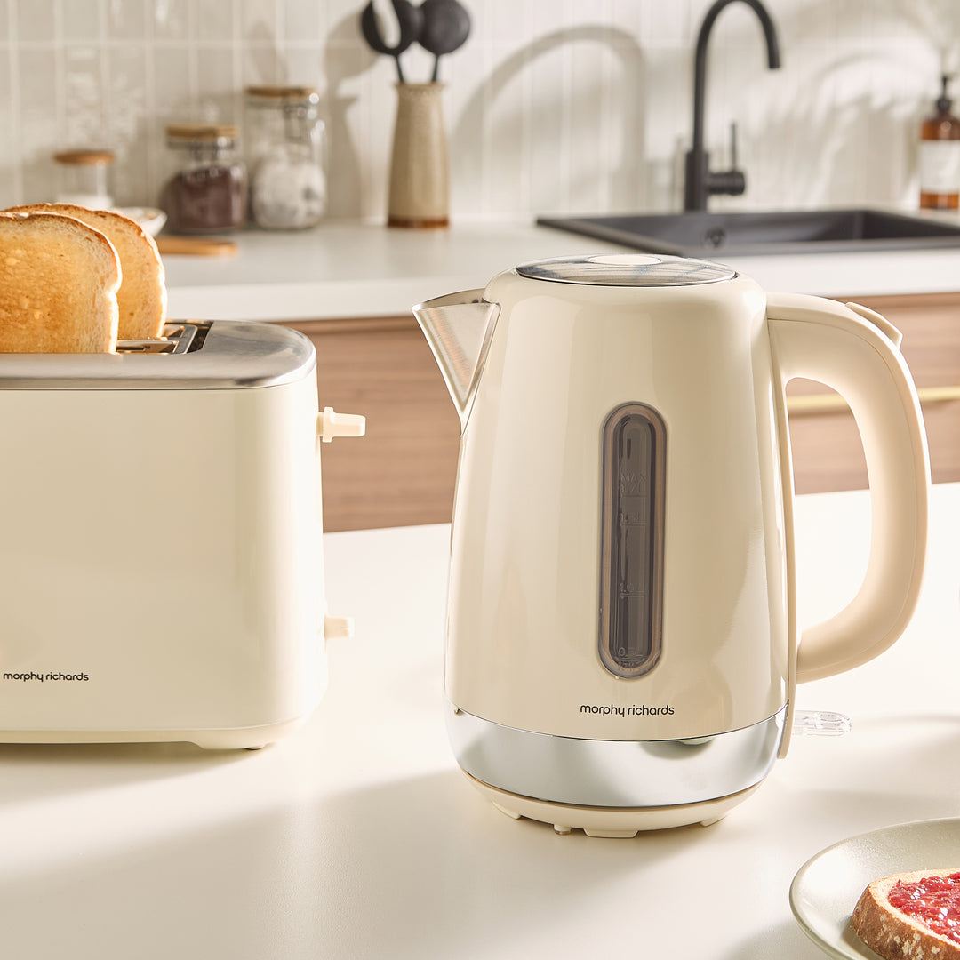 Beige kettle and toaster on a kitchen counter with a blurred background