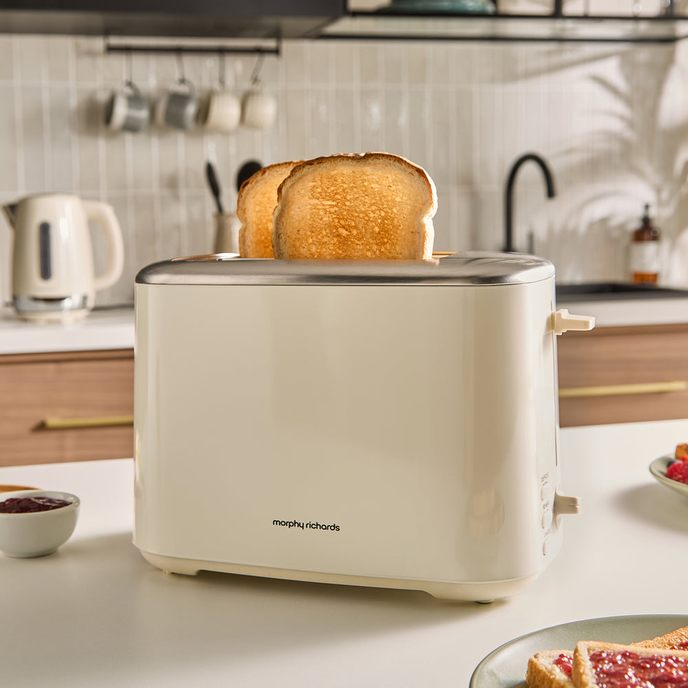 Beige toaster with slices of toast on a kitchen counter