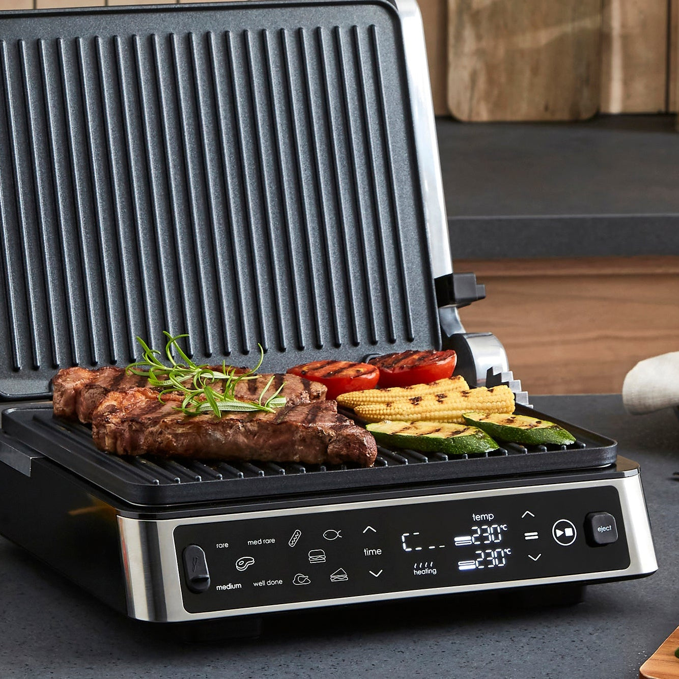 Multifunctional grill with food on a kitchen counter